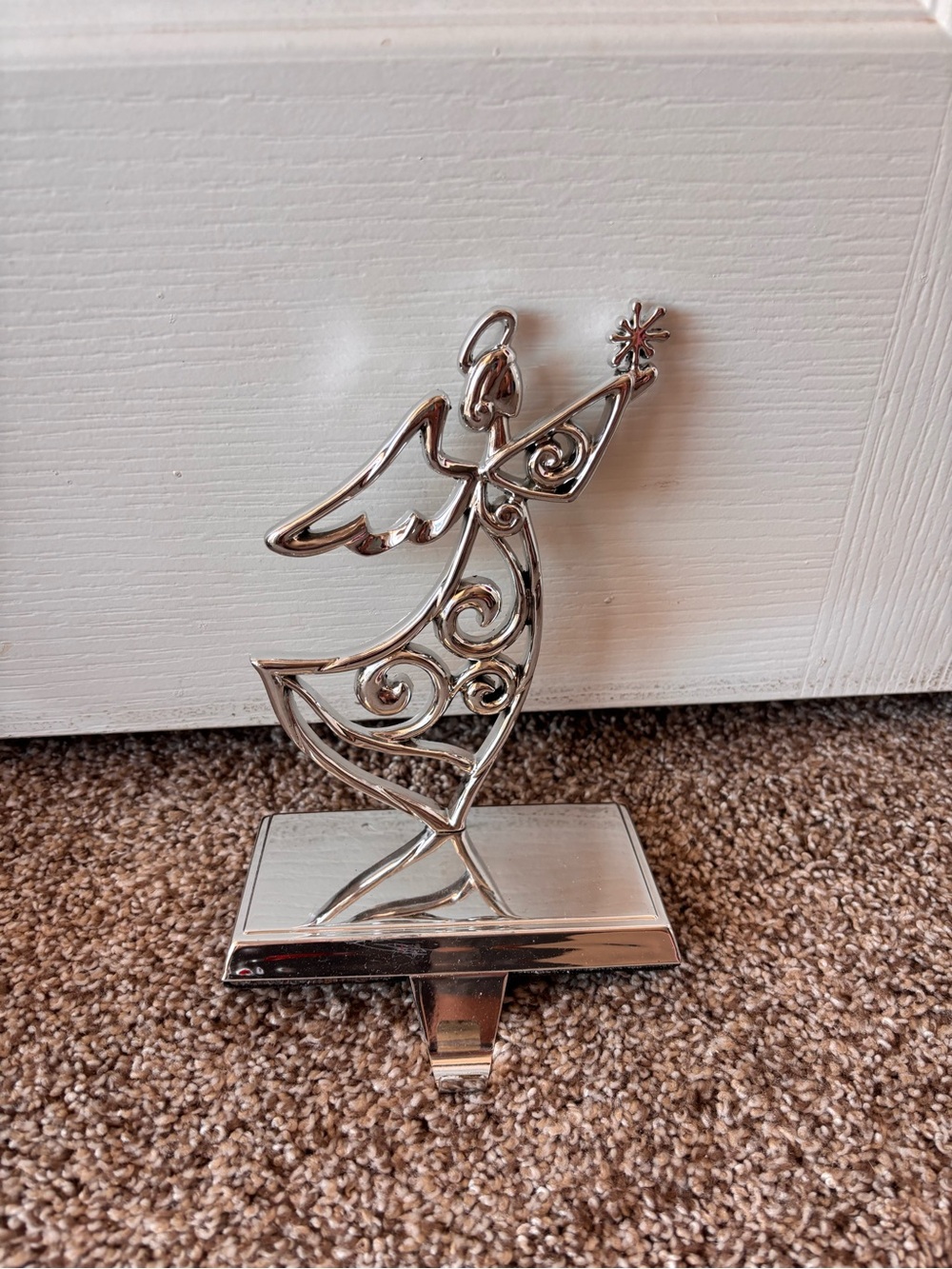 Silver colored metal angel Christmas stocking holder